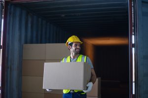 Blue collar workers are working at warehouse. Logistics, transportation.